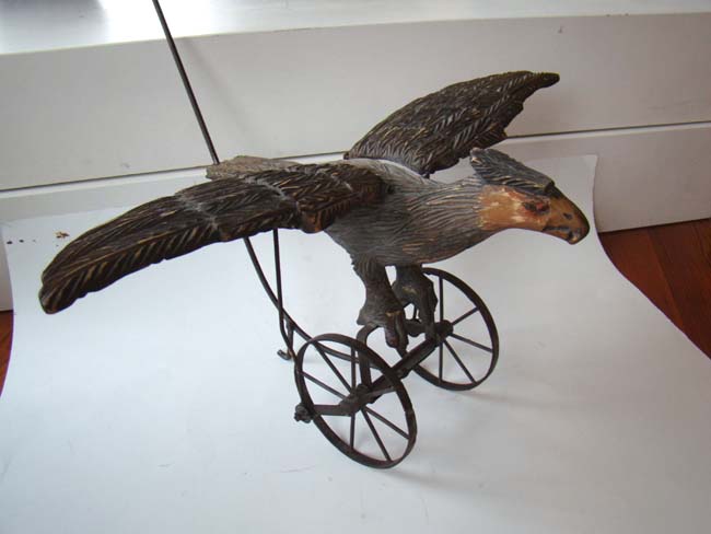 A late Victorian carved wooden spread wing eagle push toy